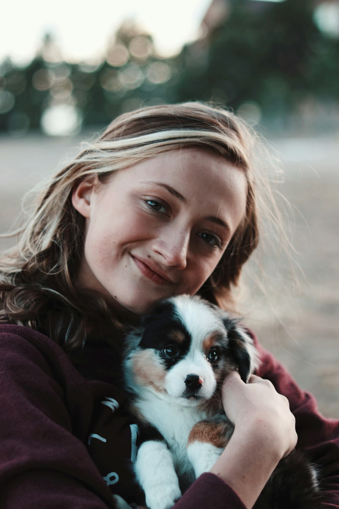 smiling-woman-hugging-puppy-cxqgs12wfhc